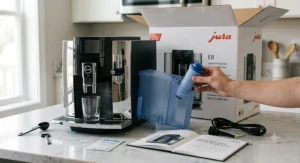 Unboxing the Jura E8 espresso machine showing the water reservoir and Smart CLEARYL filter setup